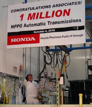 HPPG Logistics Associate Eddie Long shows off the one millionth automatic transmission produced today.
